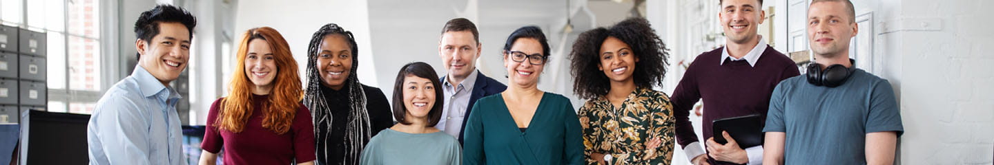 A group photo of business professionals in an office.