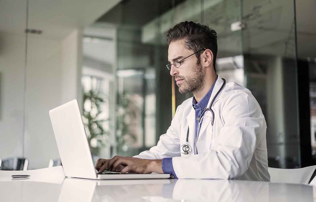 Doctor using a laptop computer.