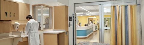 Doctor washing hands in patient room at DMC Children's Hospital of Michigan.