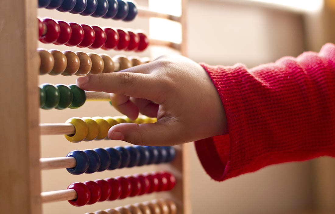 Child hand playing with an abacus