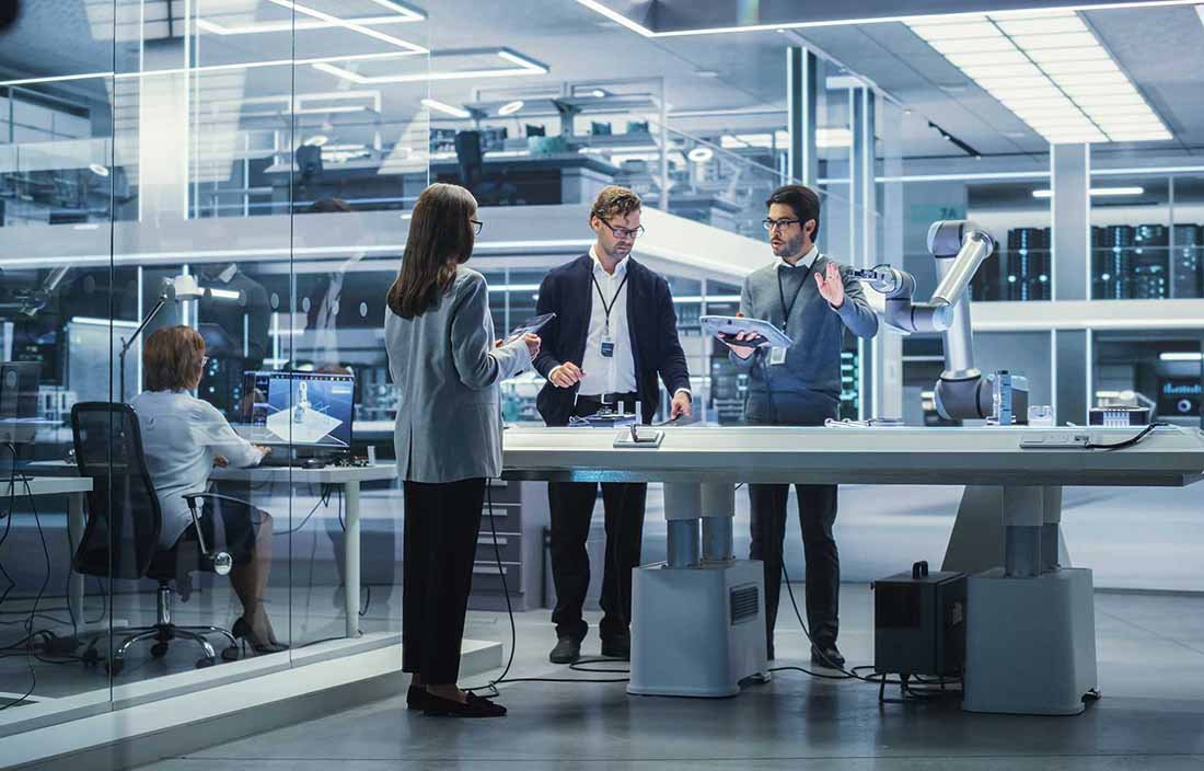 IT professionals working in a futuristic office and discussing AI and new technologies.