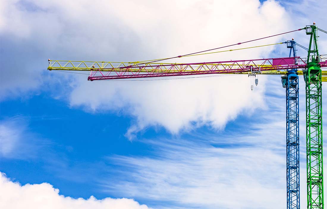 Image of building cranes against the sky
