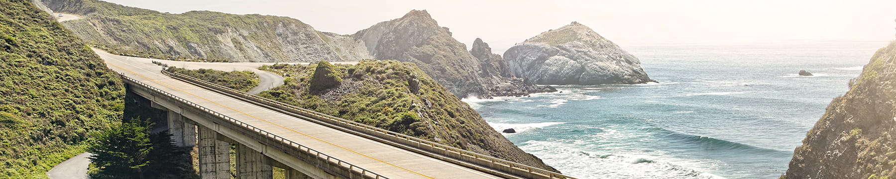 View of a road through a mountain countryside.