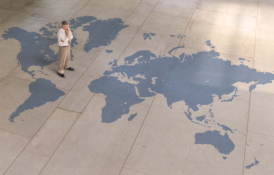 Image of man standing of large flat map