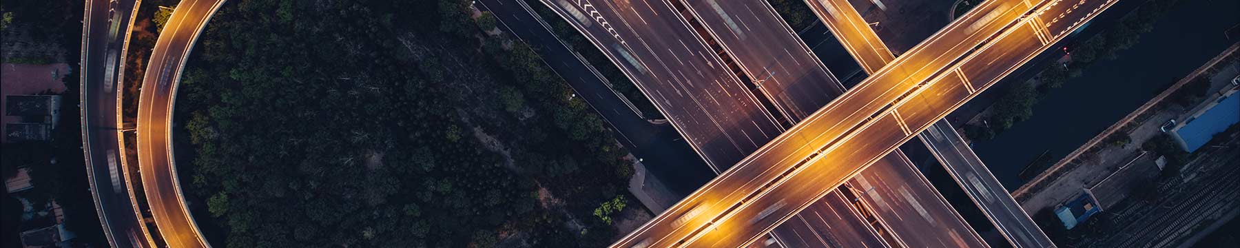 Top down view of a highway and roads at dusk. 