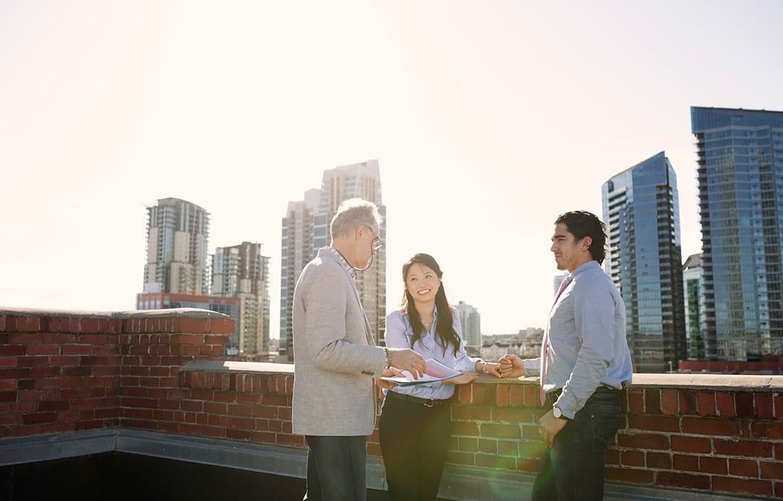 People meeting with city skyline in the background