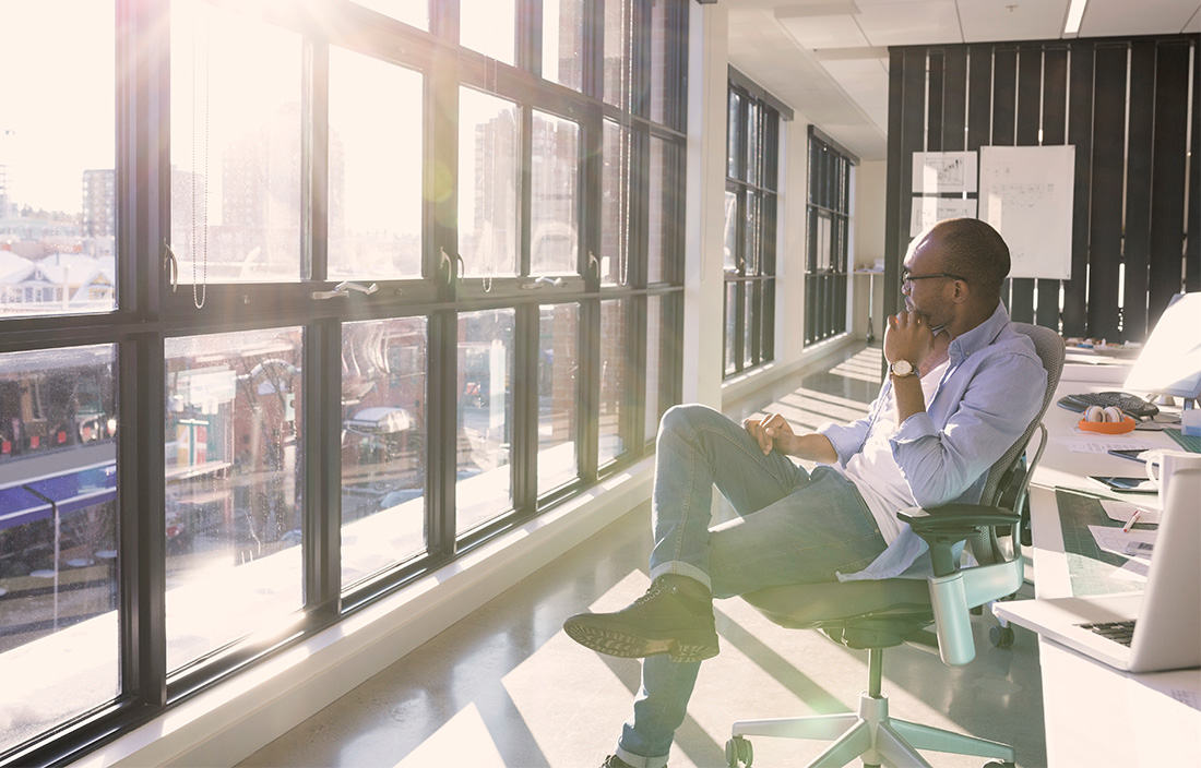 Image of a man looking out the window