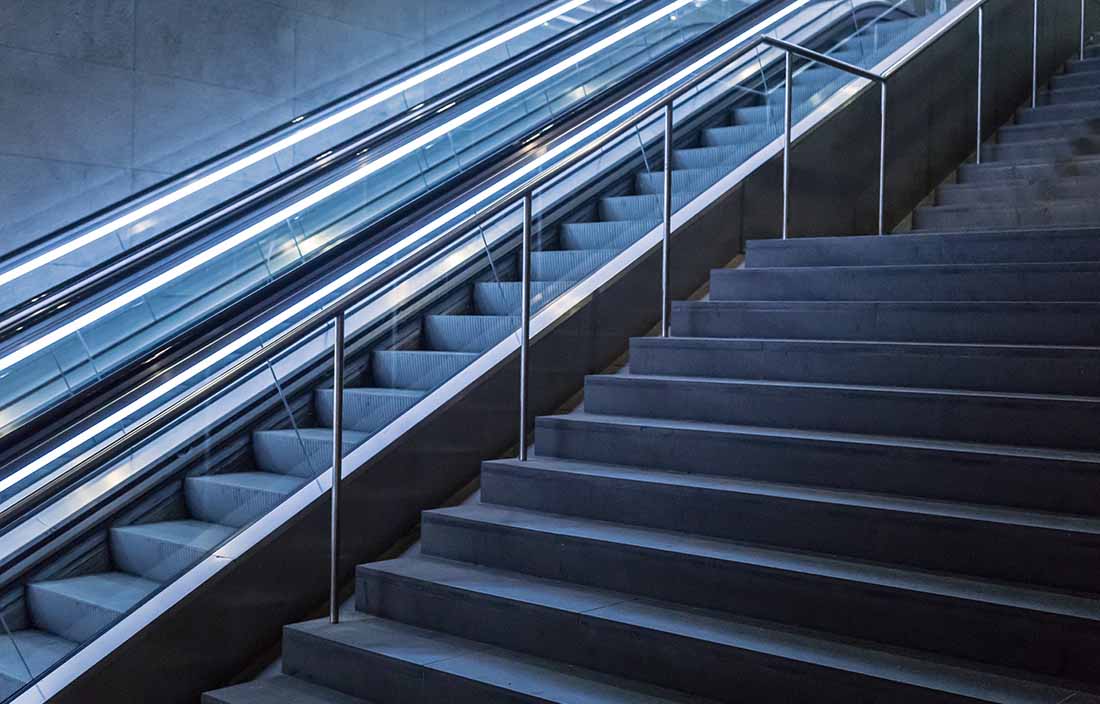 Stairway with an escalator next to it.