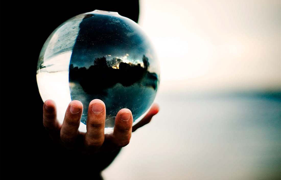 A person holding a glass ball