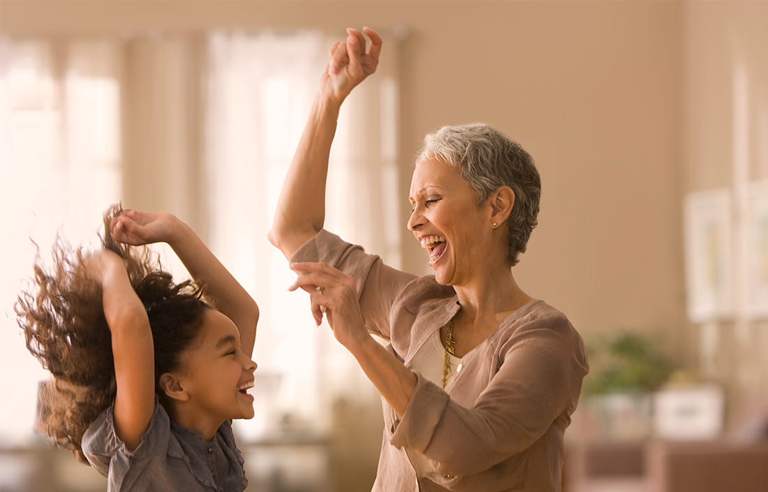 Grandmother and granddaughter dancing