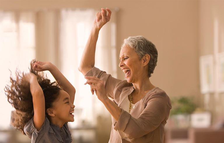 Grandmother and granddaughter dancing