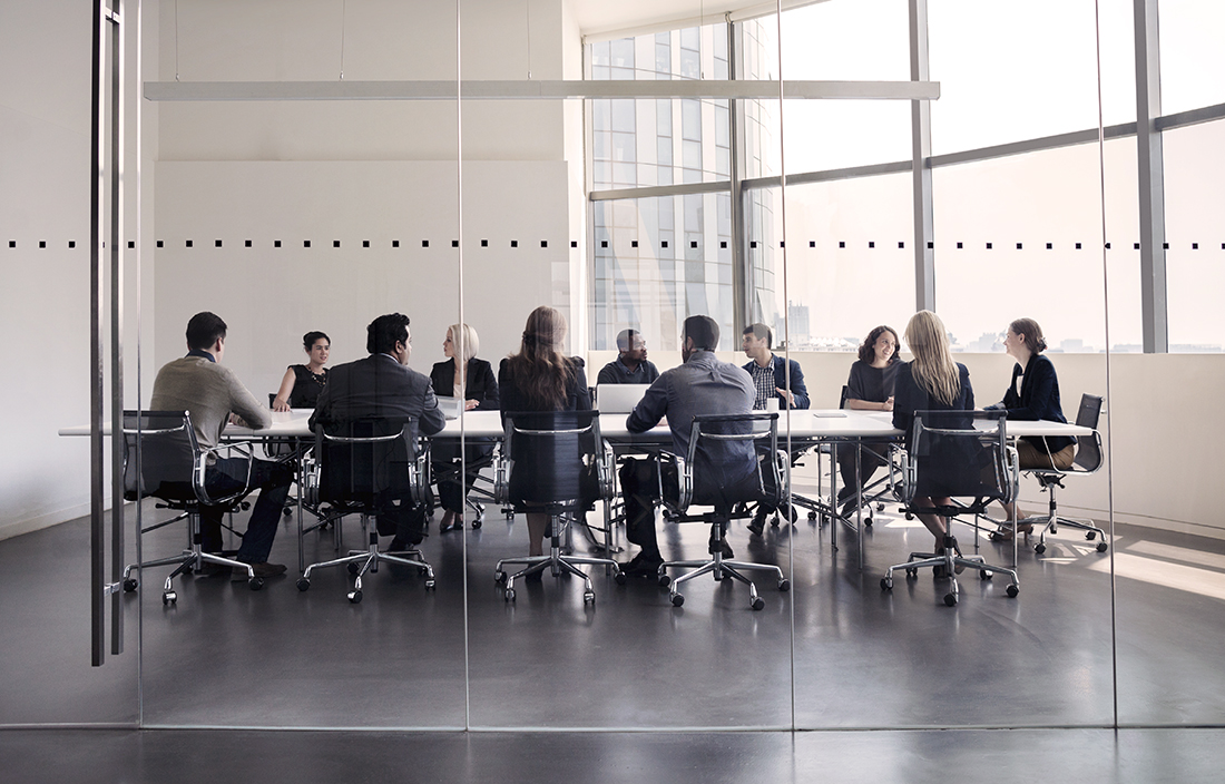 A group of people meeting in a conference room