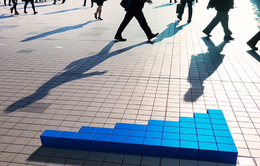 Reflection of people walking on a sidewalk 