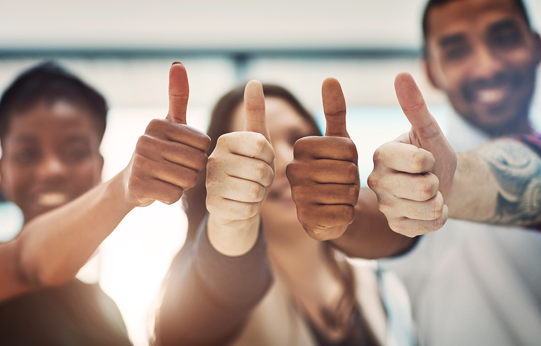 Image of business people giving thumbs up
