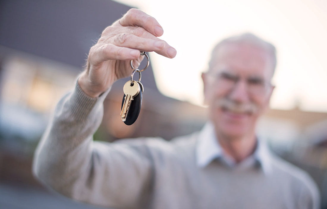 Image of elderly man holding keys.
