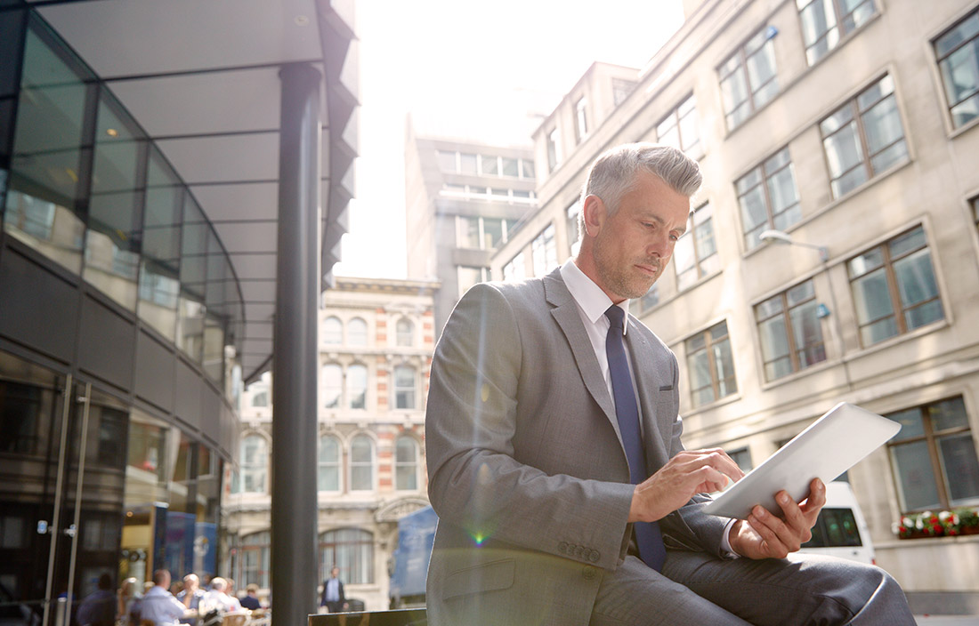 Image of man in front of corporate building