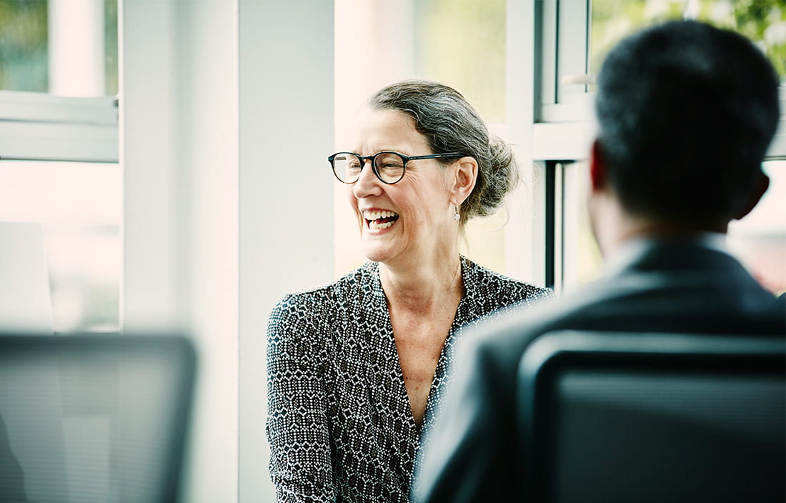 Woman laughing with advisor