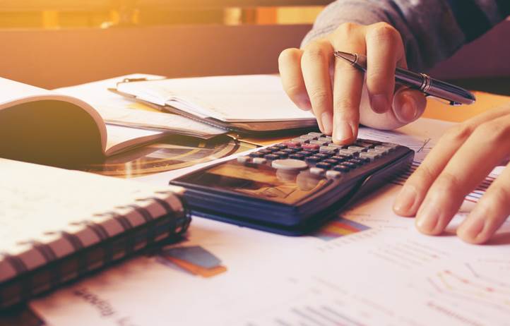 Image of person typing on calculator