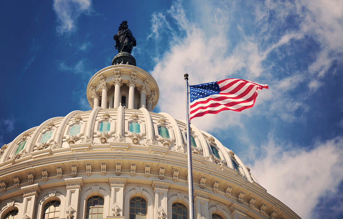 Close up image of a round building and the american flag on a flag pole