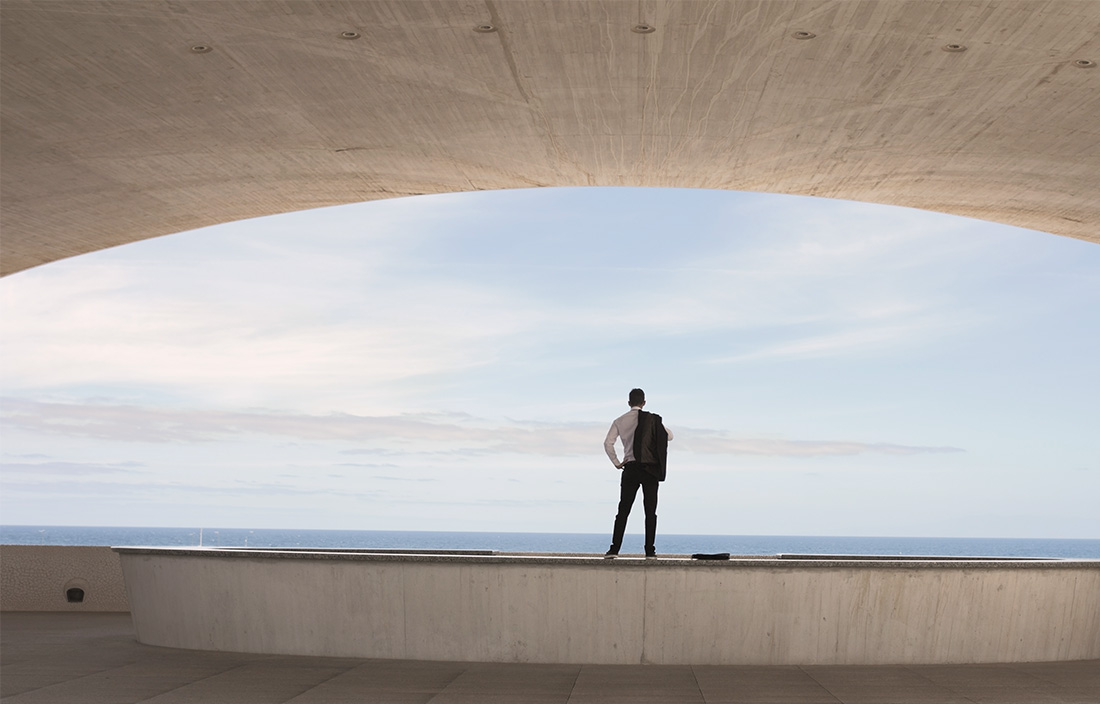 Image of man standing facing the horizon
