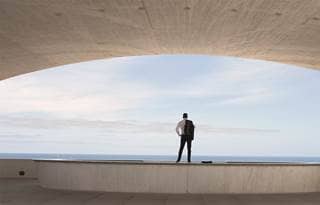 Image of man standing facing the horizon