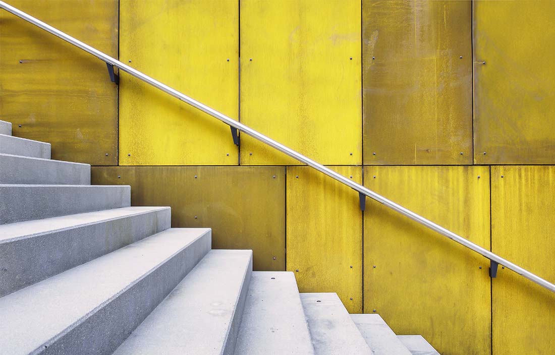Image of white stairs against yellow wall