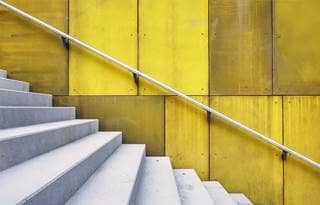 Image of white stairs against yellow wall