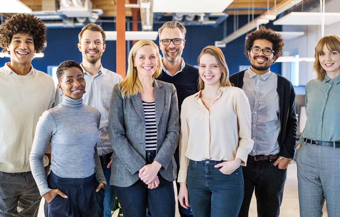 A group photo of experienced business professionals in an office.