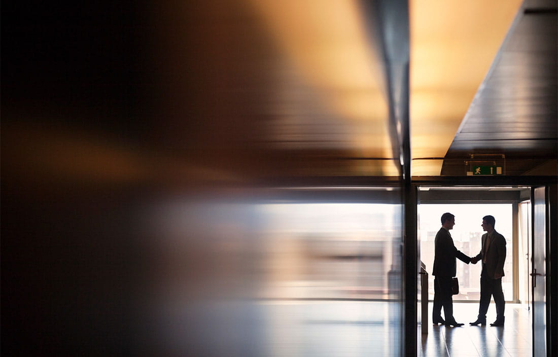 Image of two people shaking hands