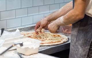 Chef making pizza.