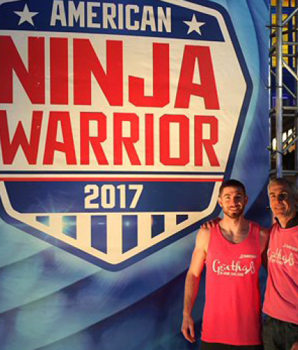 Matt Goethals in front of the American Ninja Warrior sign with his dad. 