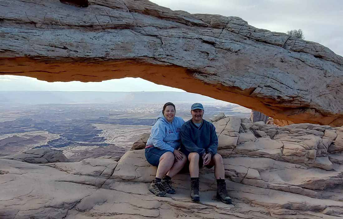 Couple sitting together in a nature scenic shot.
