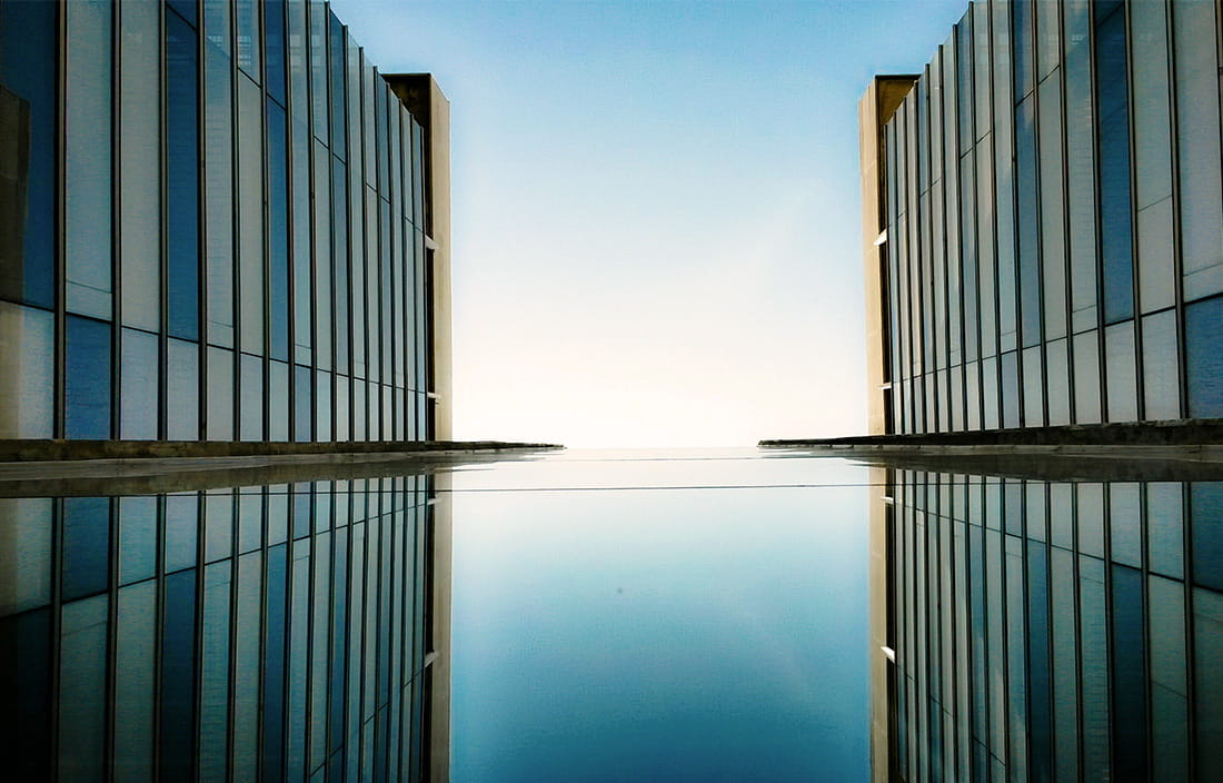 identical buildings framing water and sky