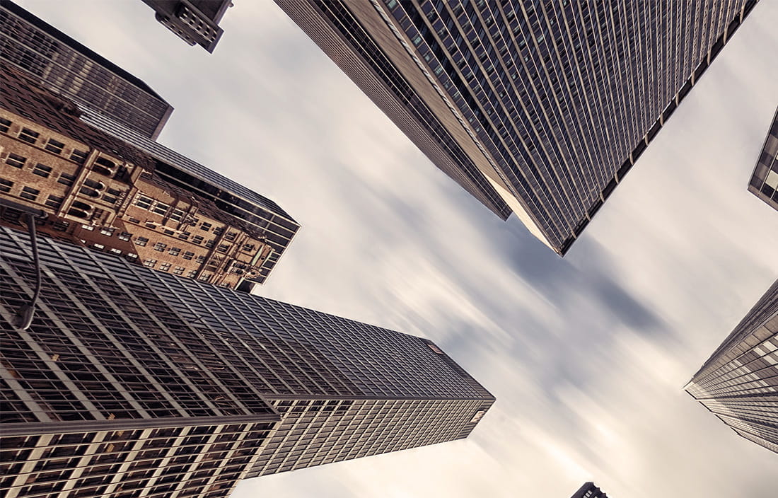 skyscrapers framing cloudy sky 