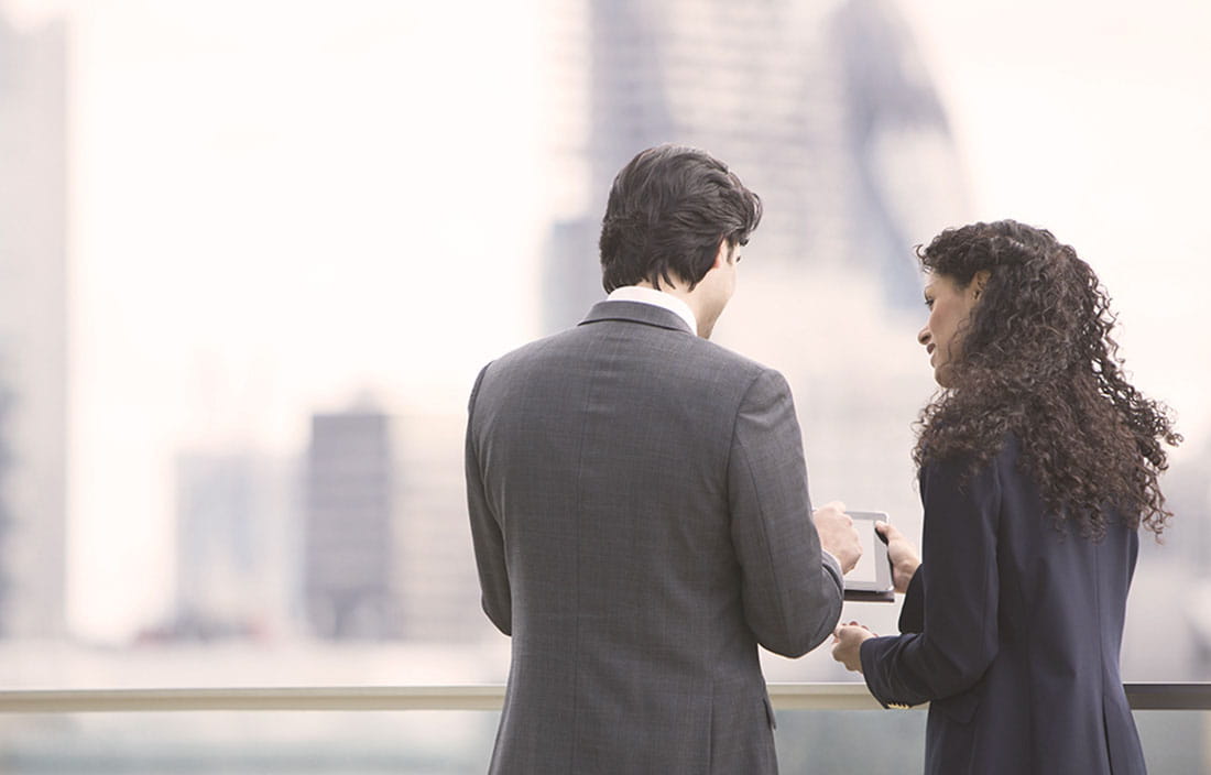 Business partners overlooking a blurred cityscape