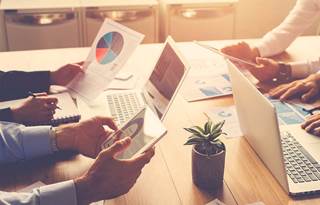 warm photo of a team working on technology