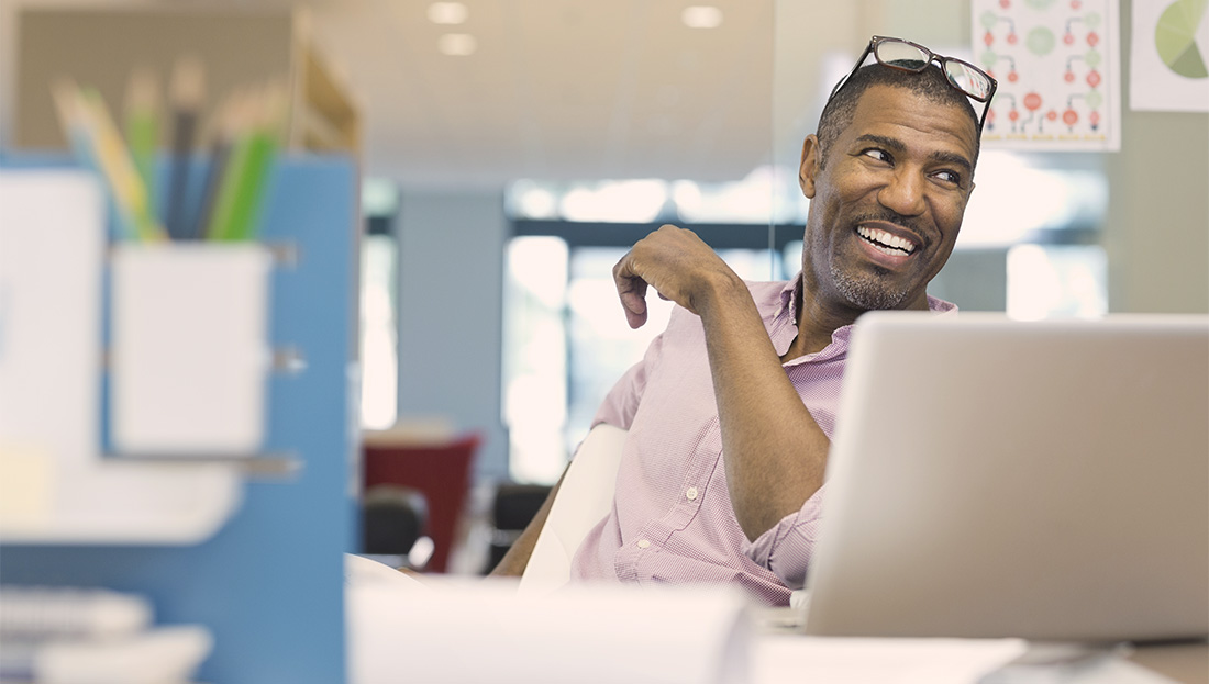 Business man smiling at his desk