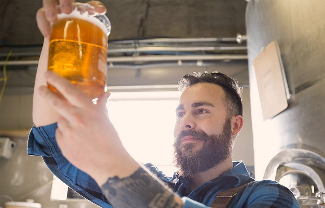 Man looking at draft beer