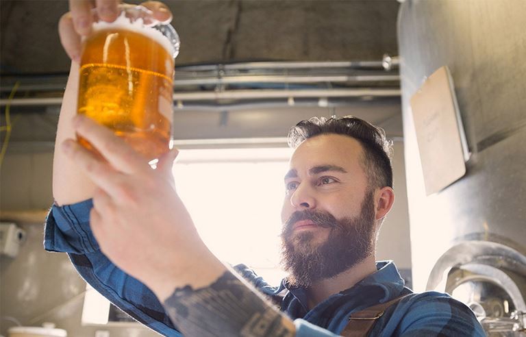 Man looking at draft beer