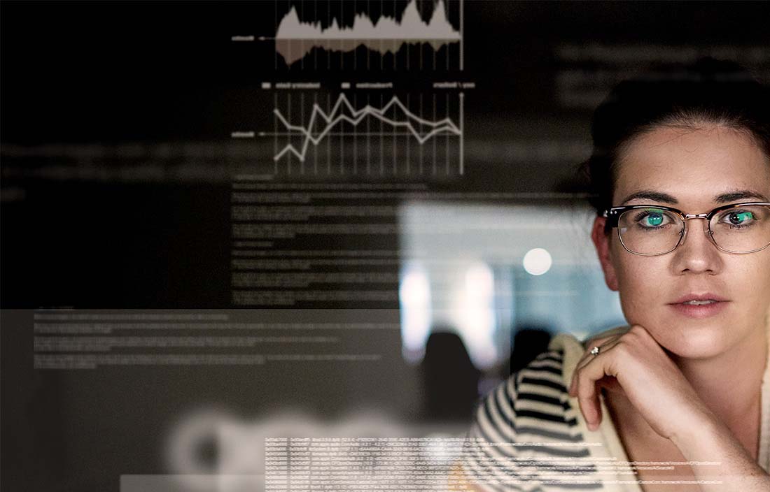 woman with glasses looking at technology 