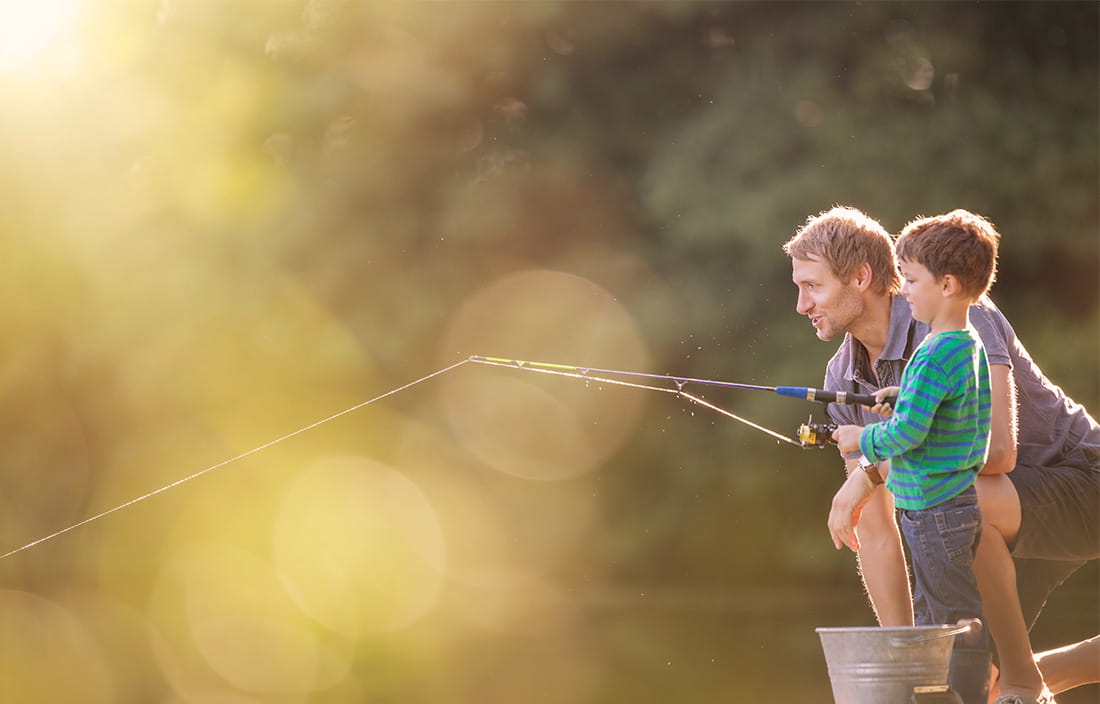 Father and young son fishing 