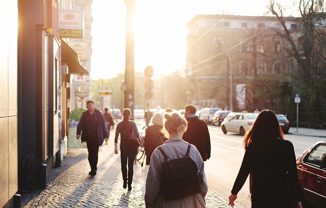 streetview of professionals walking on sidewalk