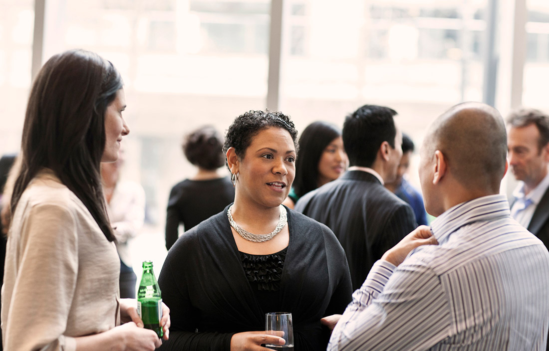 People at a mixer, talking