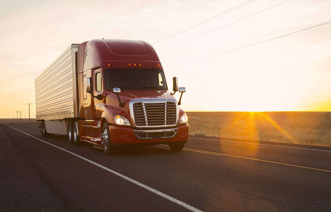 Semi truck driving down a road