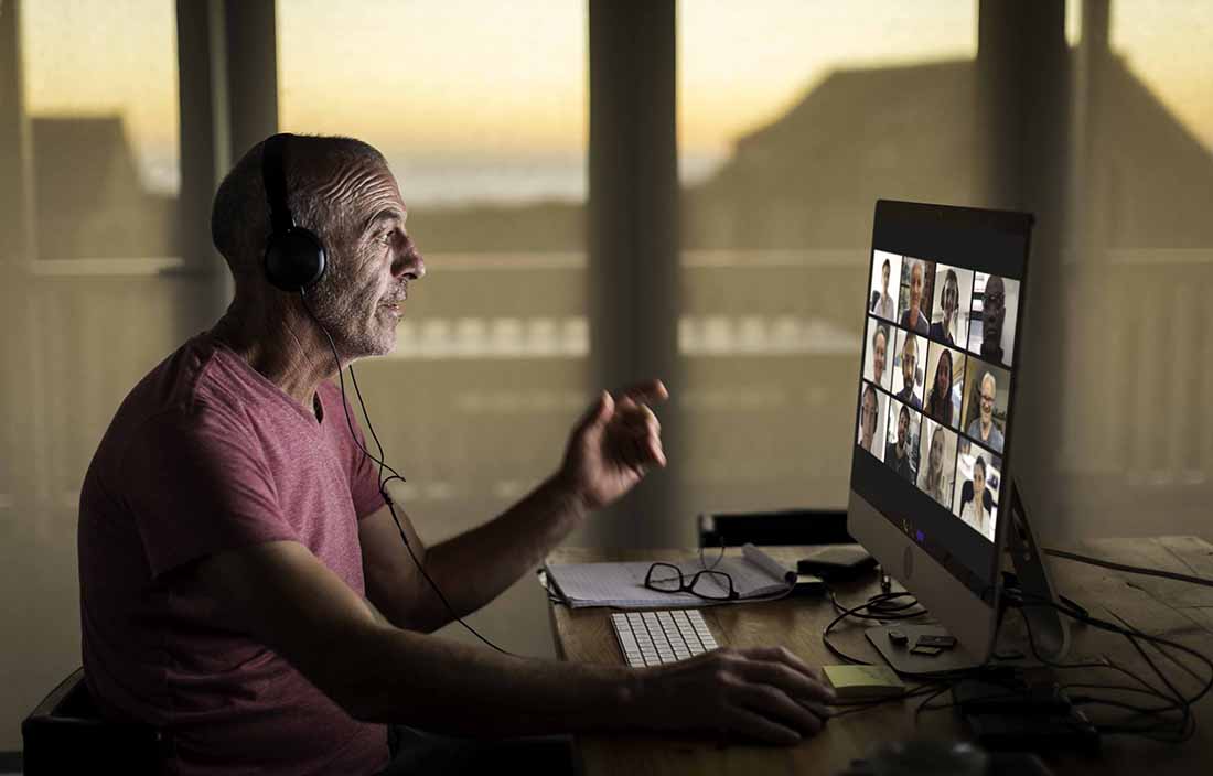 Man sitting at a desk on a Zoom call
