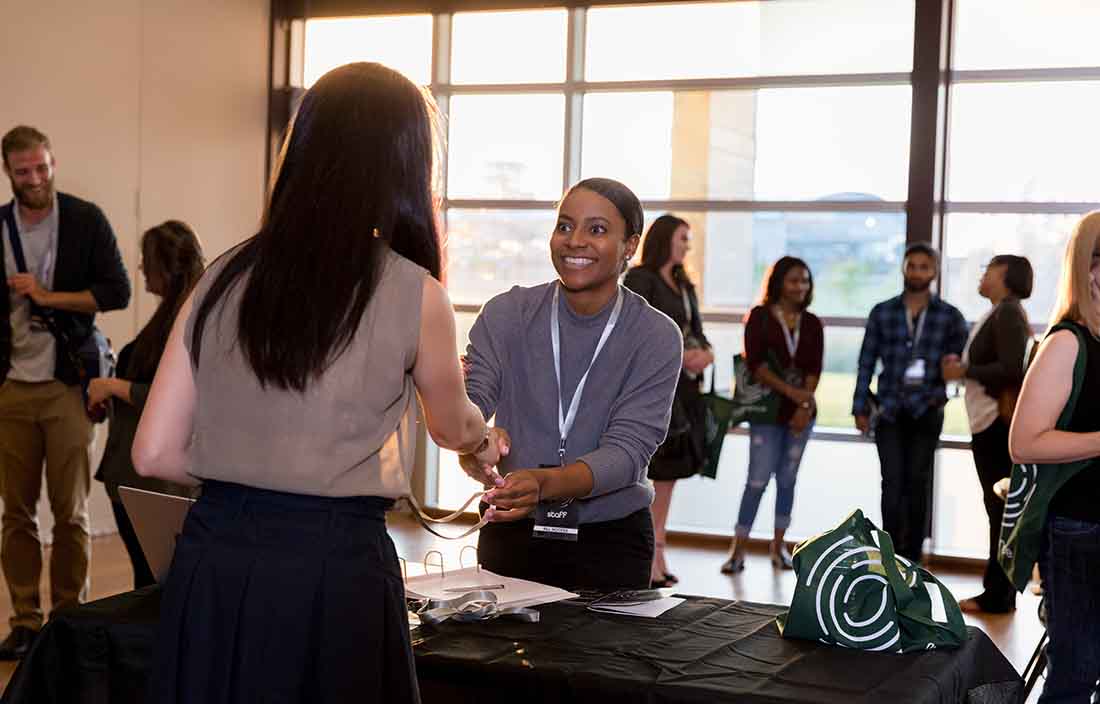 Conference attendees shaking hands.