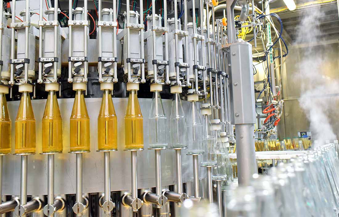 Close-up view of glass bottles in a manufacturing plant.
