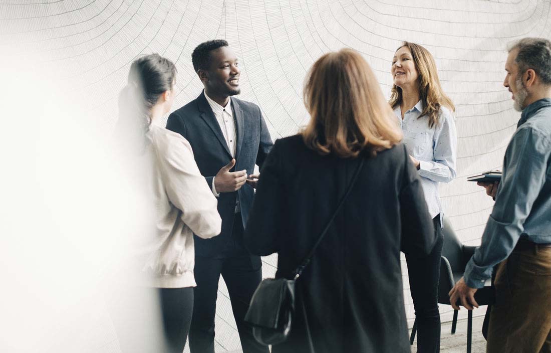 Group of business professionals laughing and talking.