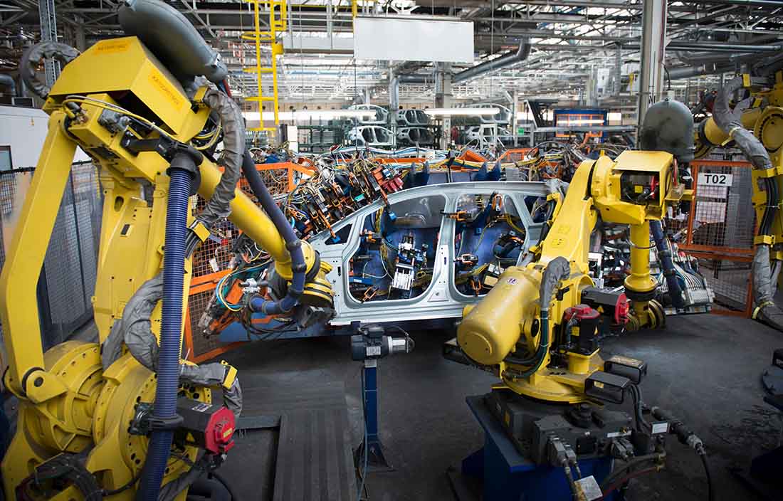 Electric vehicle being assembled in a factory.