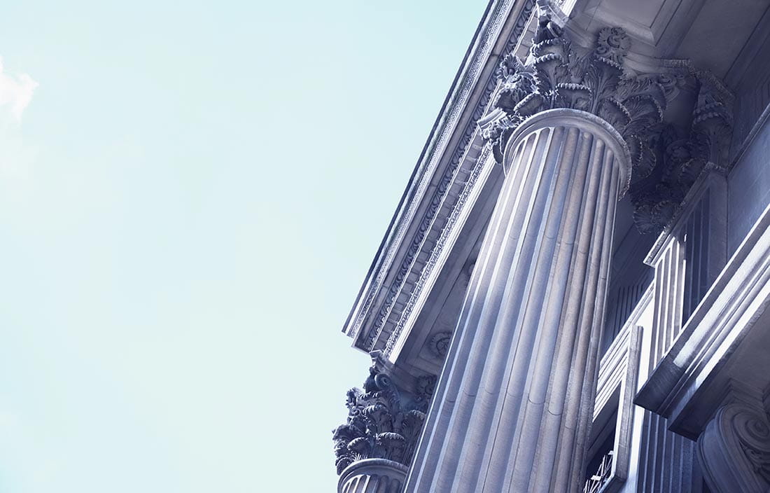 Pillar of government building against a blue sky.